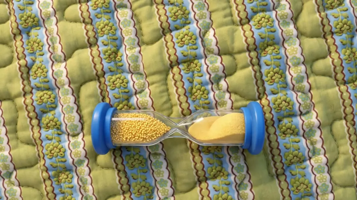 Yellow mustard seeds in hourglass timer